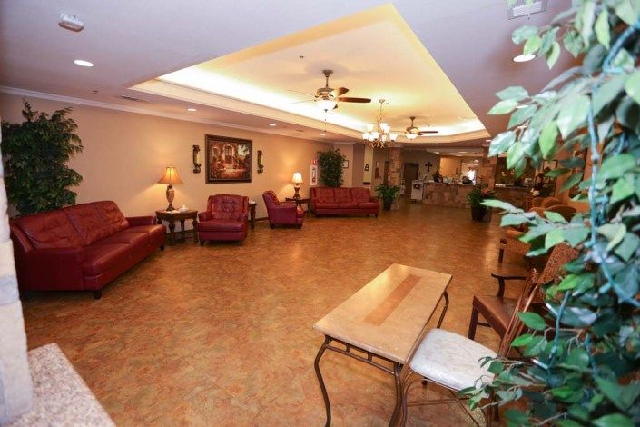 A spacious lobby with comfortable seating and warm lighting.