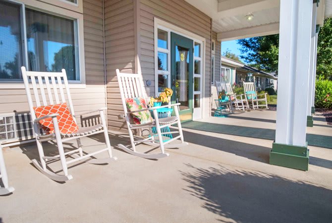 A welcoming porch featuring several rocking chairs and a cozy atmosphere.