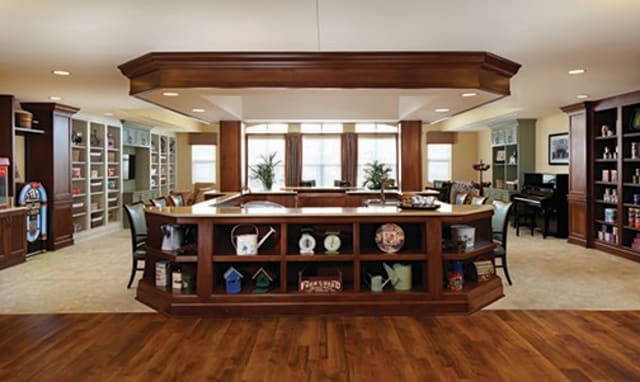 A luxurious wooden bar area with shelves displaying various decor items.
