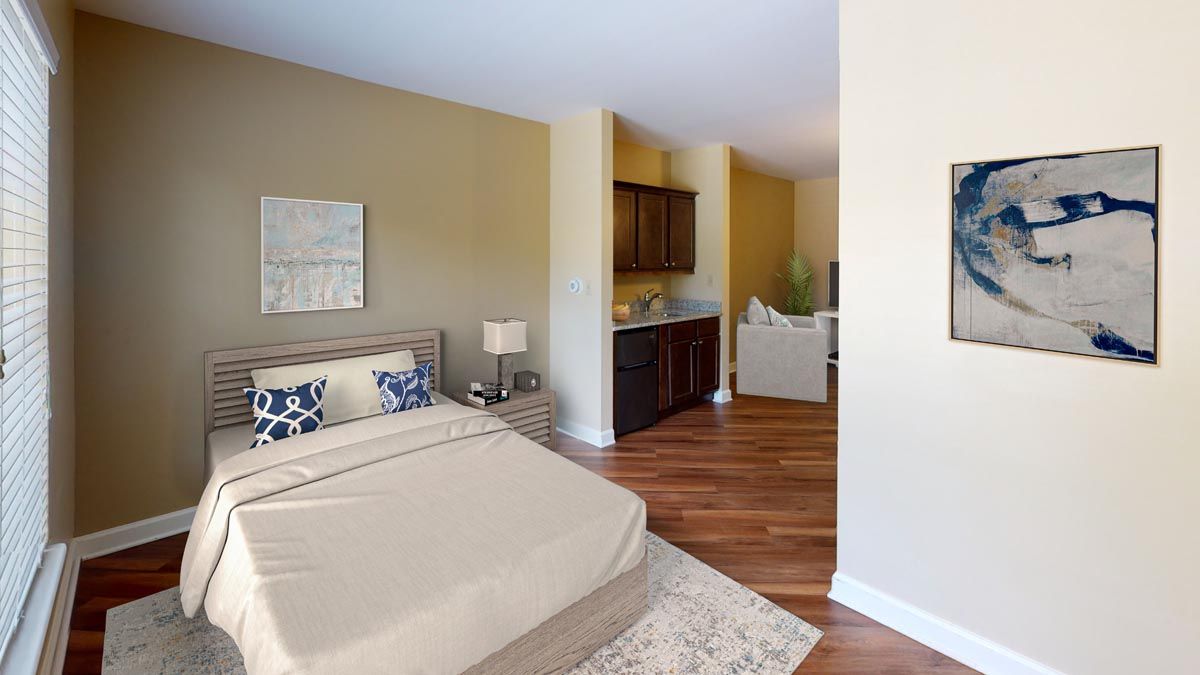 A modern bedroom featuring a comfortable bed, elegant decor, and hardwood flooring.