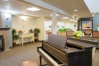 A cozy interior space featuring a piano and elegant decor.