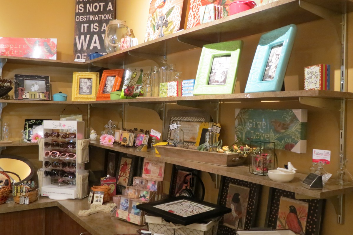 A gift shop display featuring shelves filled with picture frames, decorations, and various merchandise.
