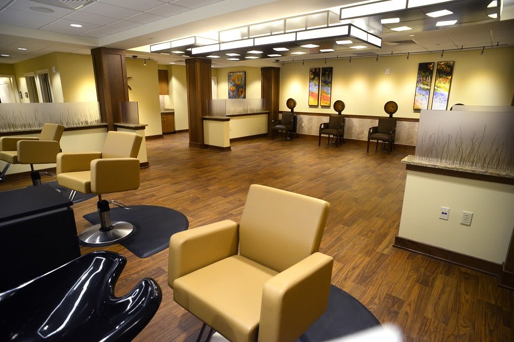 A modern salon interior with stylish chairs and warm lighting.