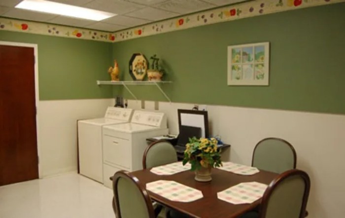 A cozy laundry room with a dining table and decorative elements.