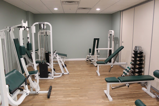 A well-equipped gym space featuring various strength training machines.