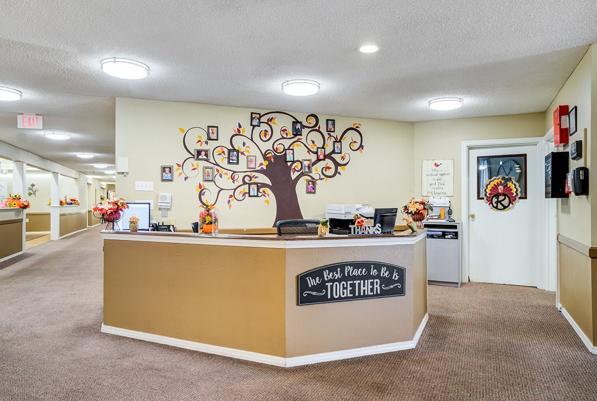 A welcoming office reception area adorned with tree-themed wall art and decorative elements.