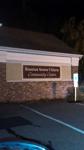 A sign for the Boonton Senior Citizens Community Center, illuminated at night.