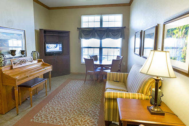 A cozy living room with a sofa, table, and TV.