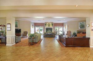 A spacious and elegant lobby with comfortable seating and a reception desk.