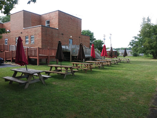 Outdoor picnic area with tables and umbrellas, perfect for enjoying a meal in the park.