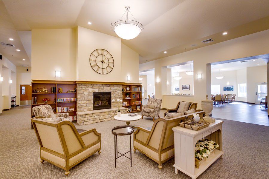 A cozy living room with a fireplace, comfortable seating, and elegant decor.
