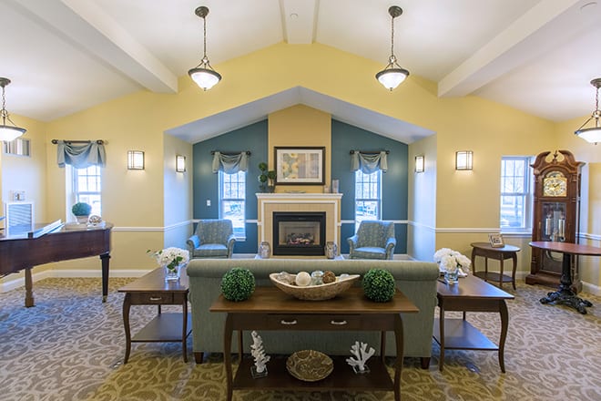 A cozy living room with a fireplace and traditional decor.