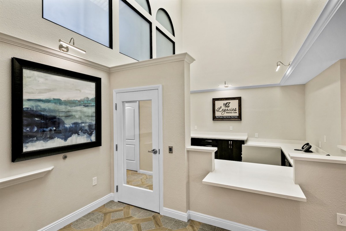 Modern office reception area with artwork and large windows.
