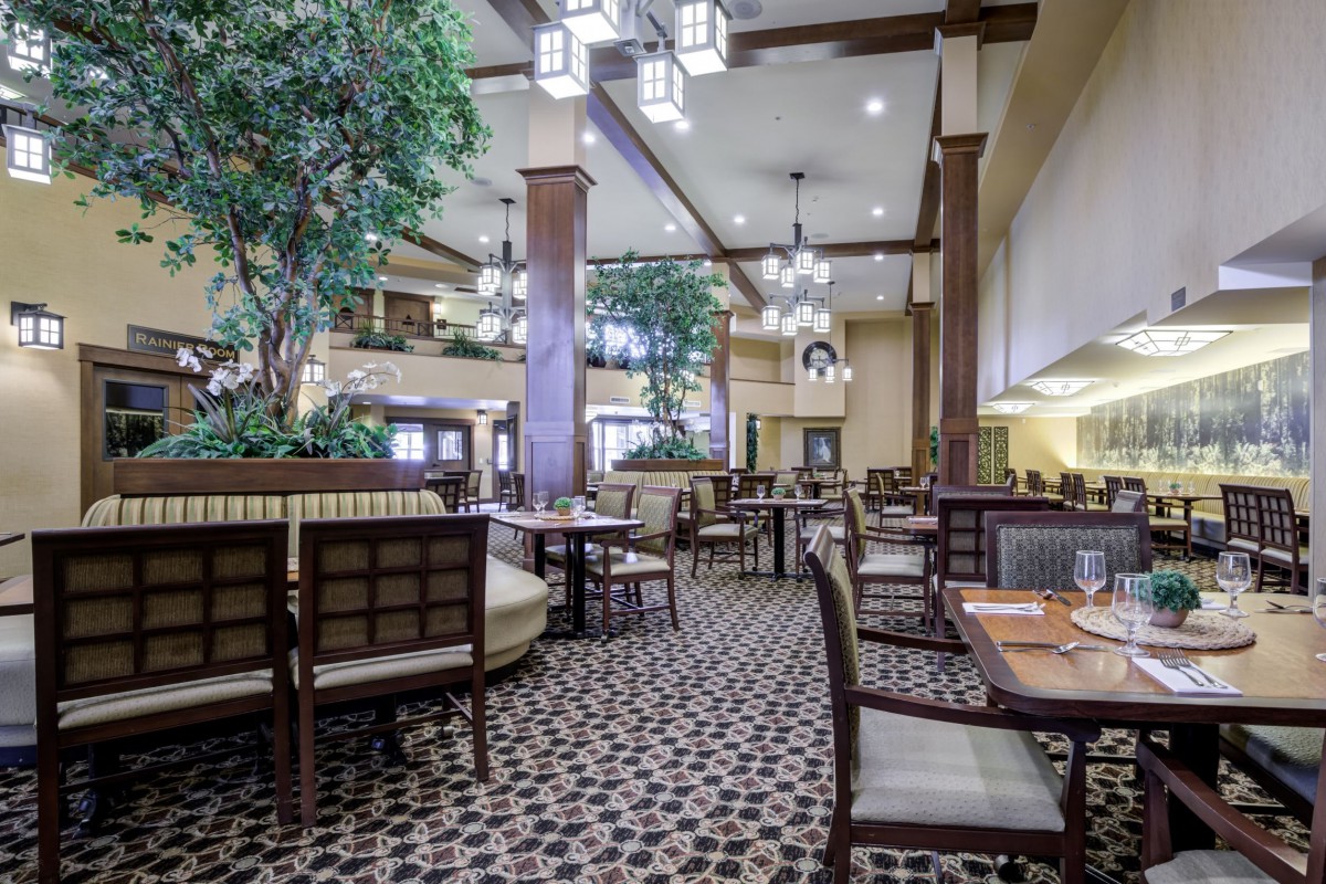 Spacious restaurant interior with elegant lighting and comfortable seating.