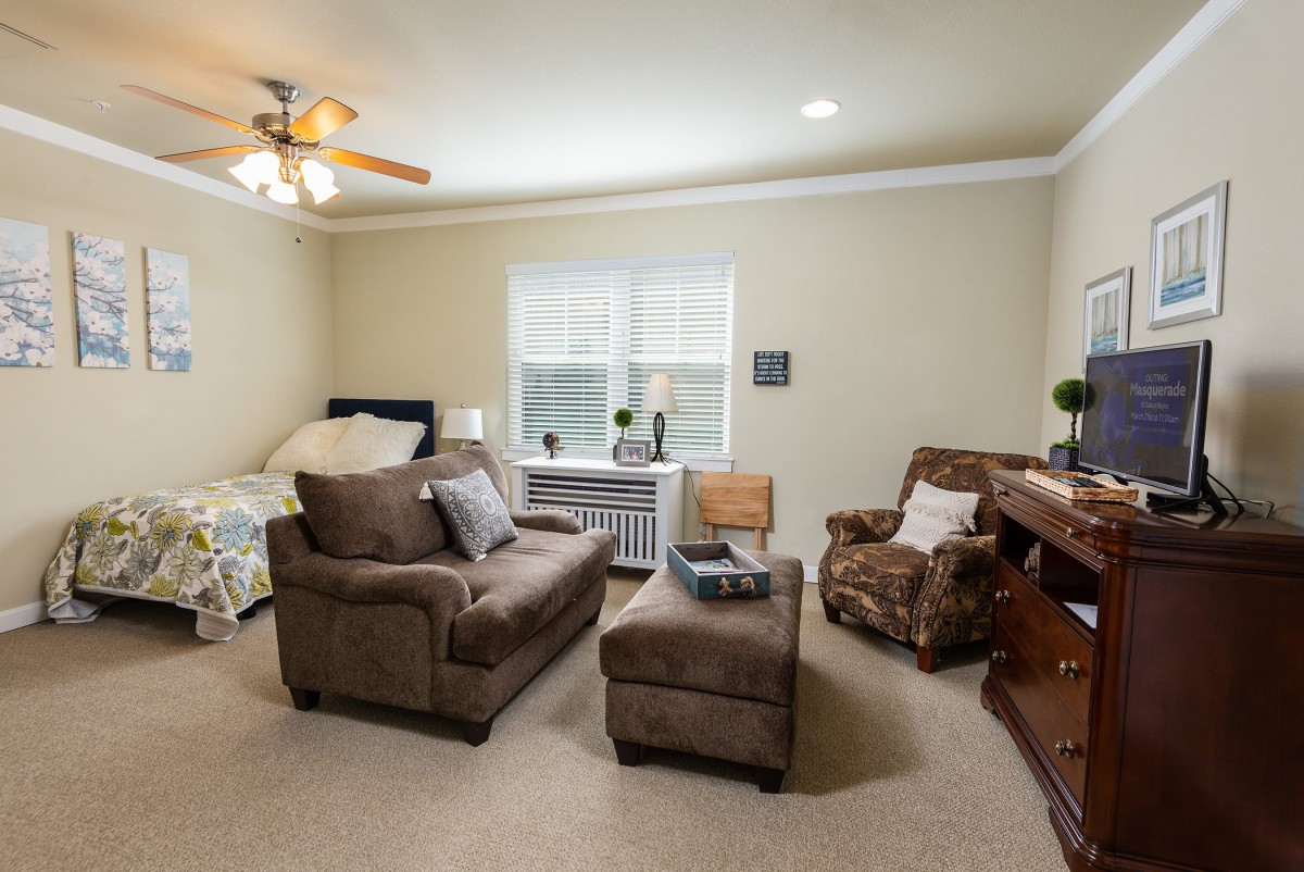 A cozy living room with comfortable seating and natural light from the window.
