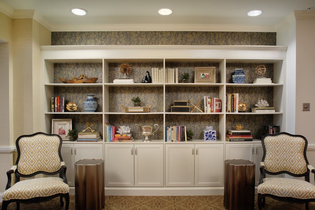 A cozy living room with neatly organized bookshelves and stylish decor.