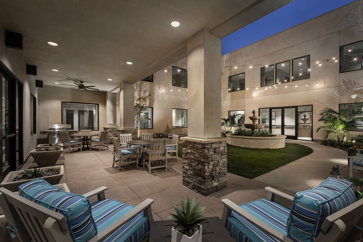 A cozy outdoor patio with seating and ambient lighting at night.