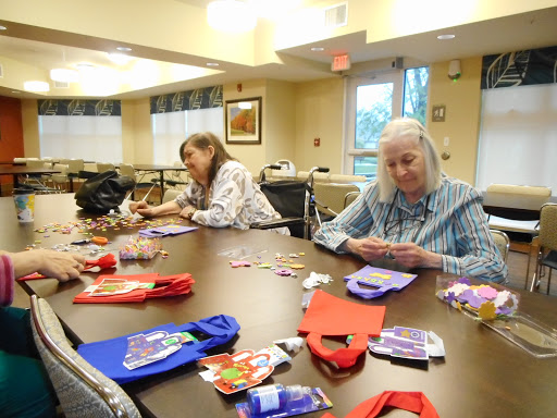 Seniors engaged in a crafting session at a community center.