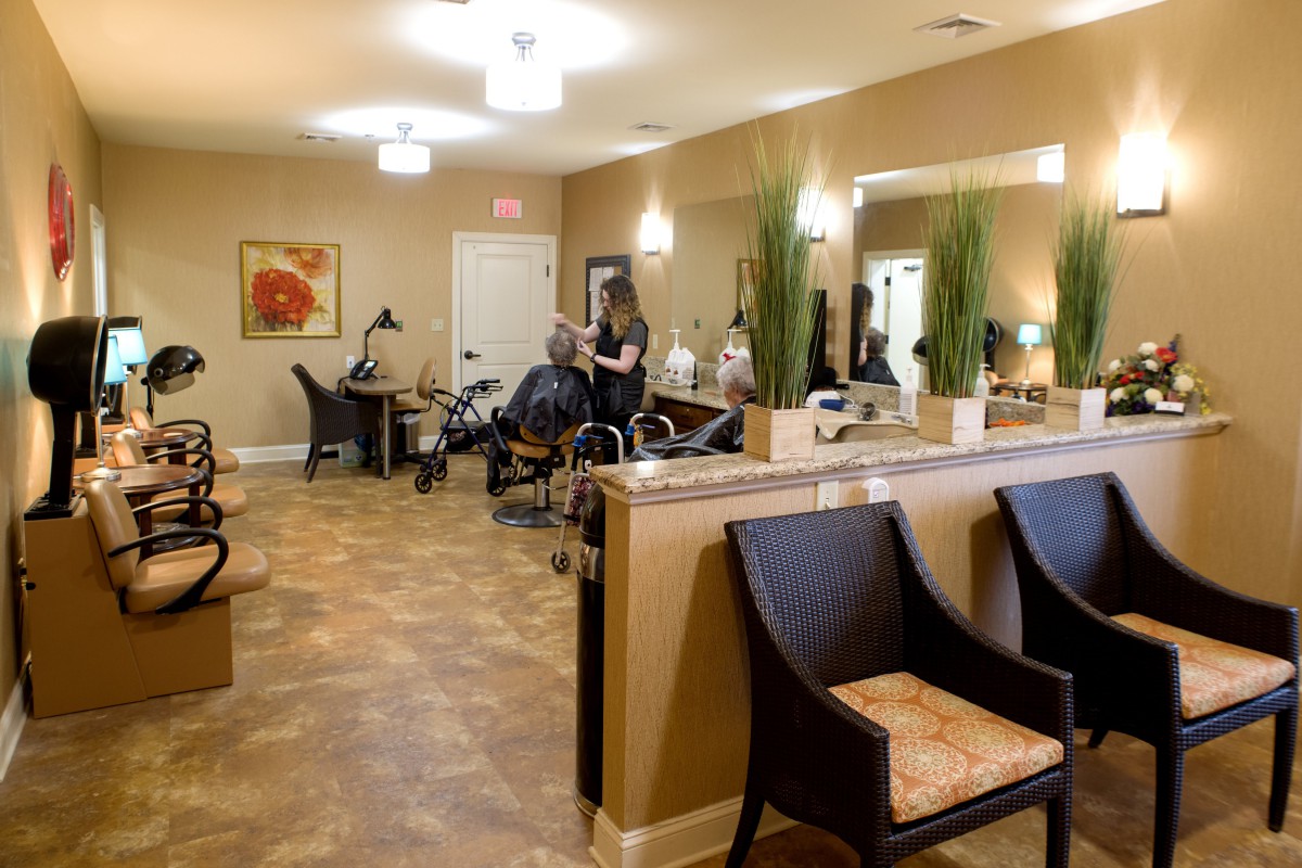 A modern salon interior with styling stations, mirrors, and a welcoming waiting area.