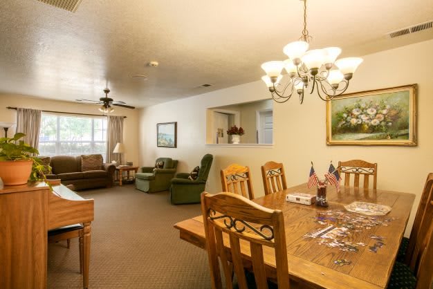 A cozy interior featuring a connected living and dining area with warm lighting.