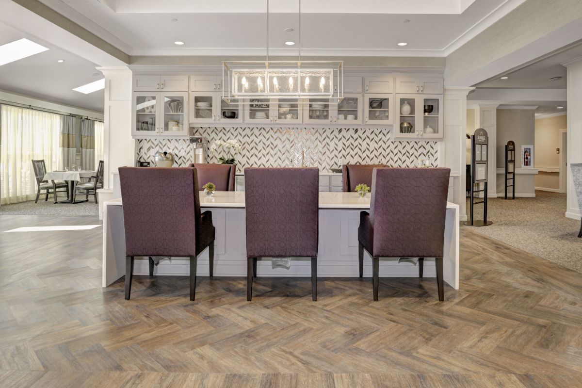 A modern kitchen and dining area with elegant seating and a stylish backsplash.