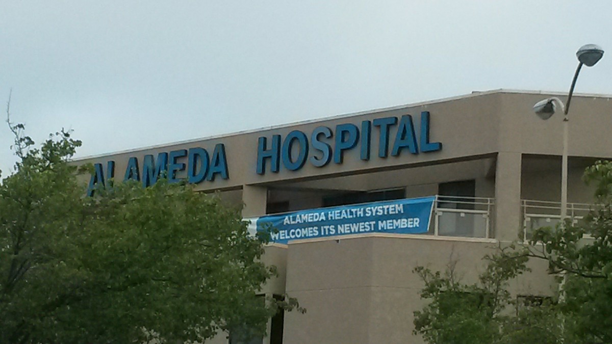 Exterior view of a hospital building with signage.