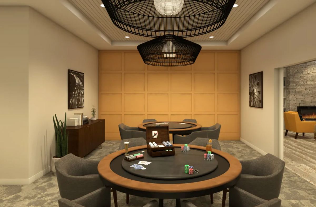 A stylish game room featuring a poker table, comfortable seating, and elegant lighting.