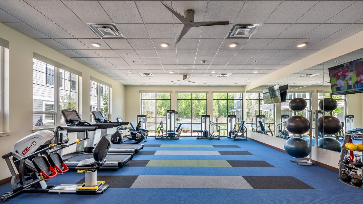 A modern gym with treadmills and various exercise equipment.