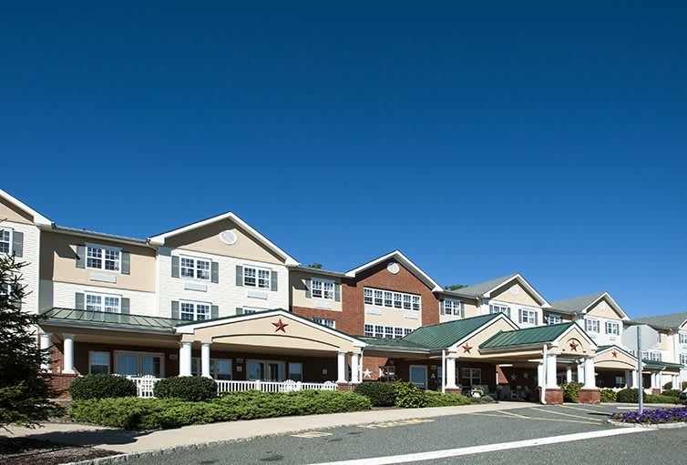 A large residential building with a clear blue sky in the background.