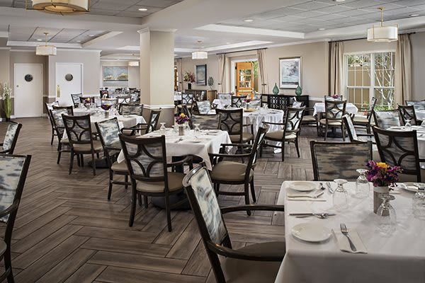 An elegant restaurant dining area set with tables and chairs, ready for guests.