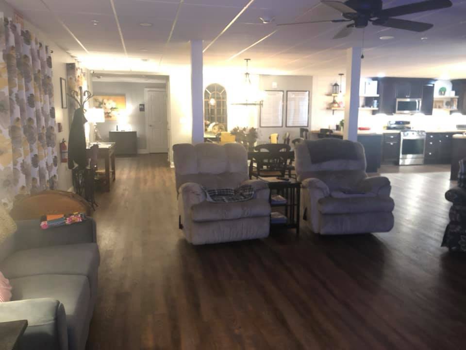 A cozy living room with comfortable seating and warm lighting.