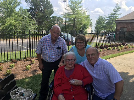A joyful moment shared among family members, celebrating together outdoors.