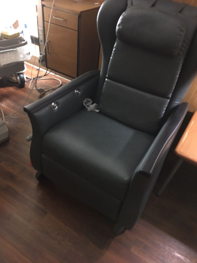 A comfortable leather recliner situated in a cozy room.