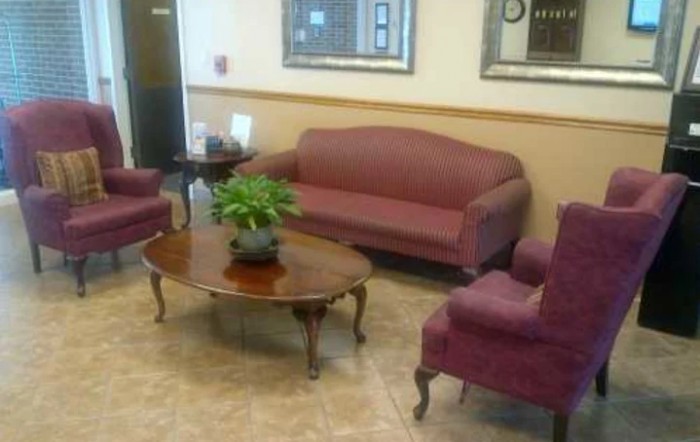 A cozy lobby waiting area with comfortable seating and a coffee table.