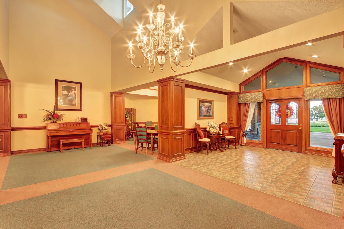 Luxurious lobby with elegant chandelier and comfortable seating.