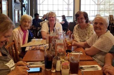 A group of women enjoying a meal together at a restaurant.
