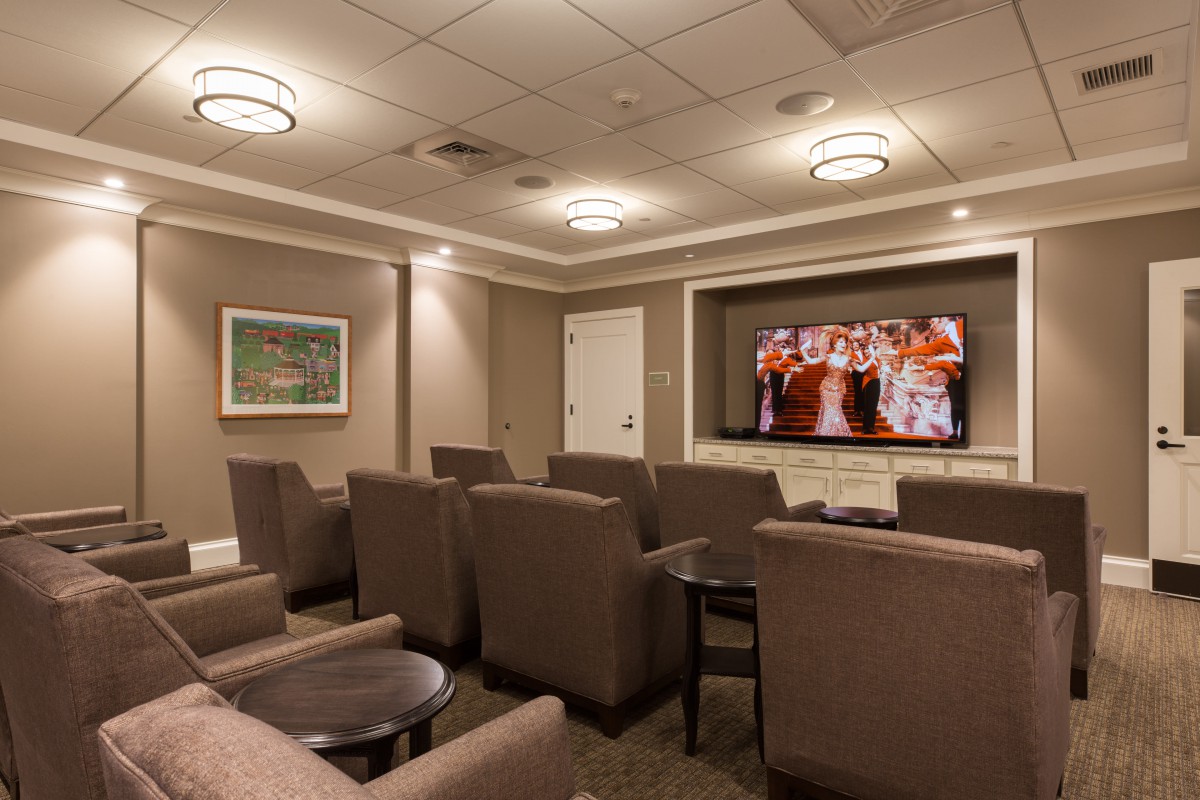Cozy home theater setup with comfortable seating and a large TV.