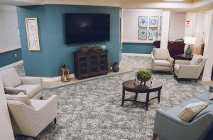 A cozy living room with a TV, comfortable seating, and tasteful decor.