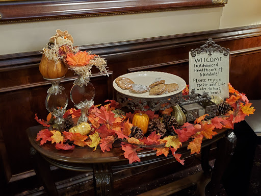 A cozy autumn display featuring colorful fall leaves, decorative pumpkins, and a plate of cookies, perfect for Thanksgiving.