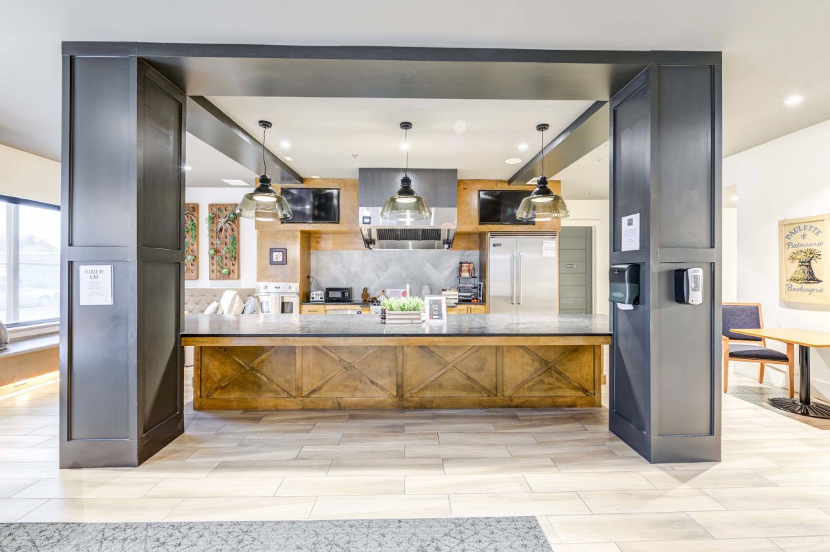 Modern kitchen with wooden accents and stainless steel appliances.