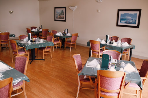 A cozy dining area featuring neatly arranged tables and chairs in a restaurant setting.