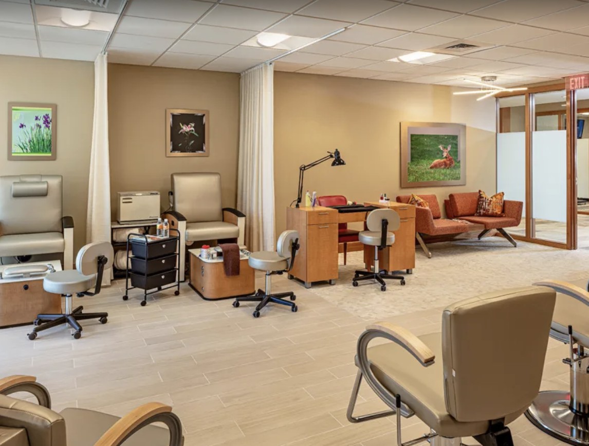 A spacious and modern nail salon interior featuring pedicure stations and a comfortable waiting area.