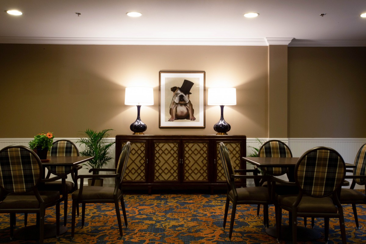 Stylishly decorated room with seating area, wall art, and warm ambient lighting.