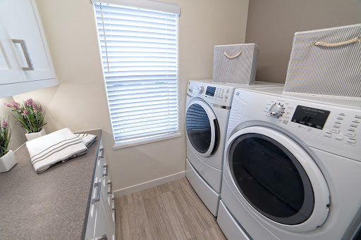 A modern laundry room featuring a washer and dryer with ample natural light.