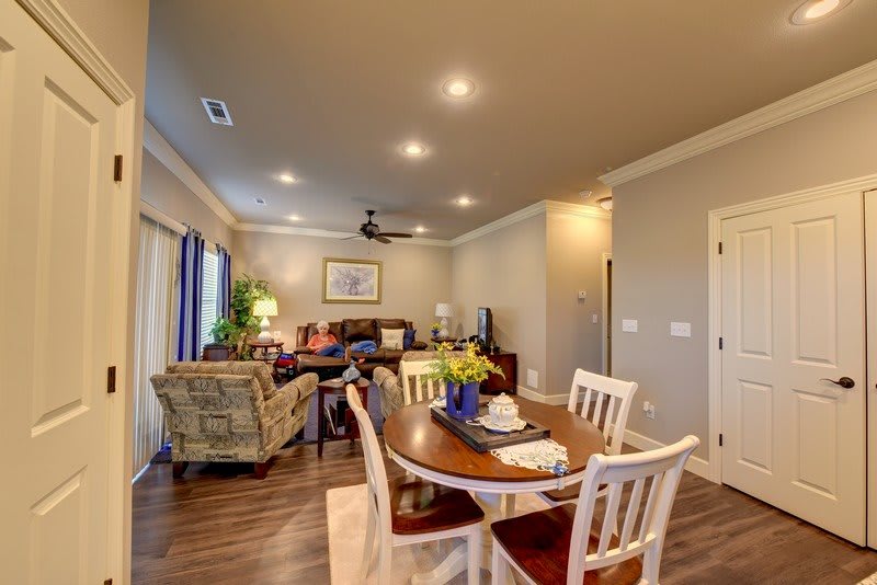 A cozy living room and dining area with modern decor and warm lighting.