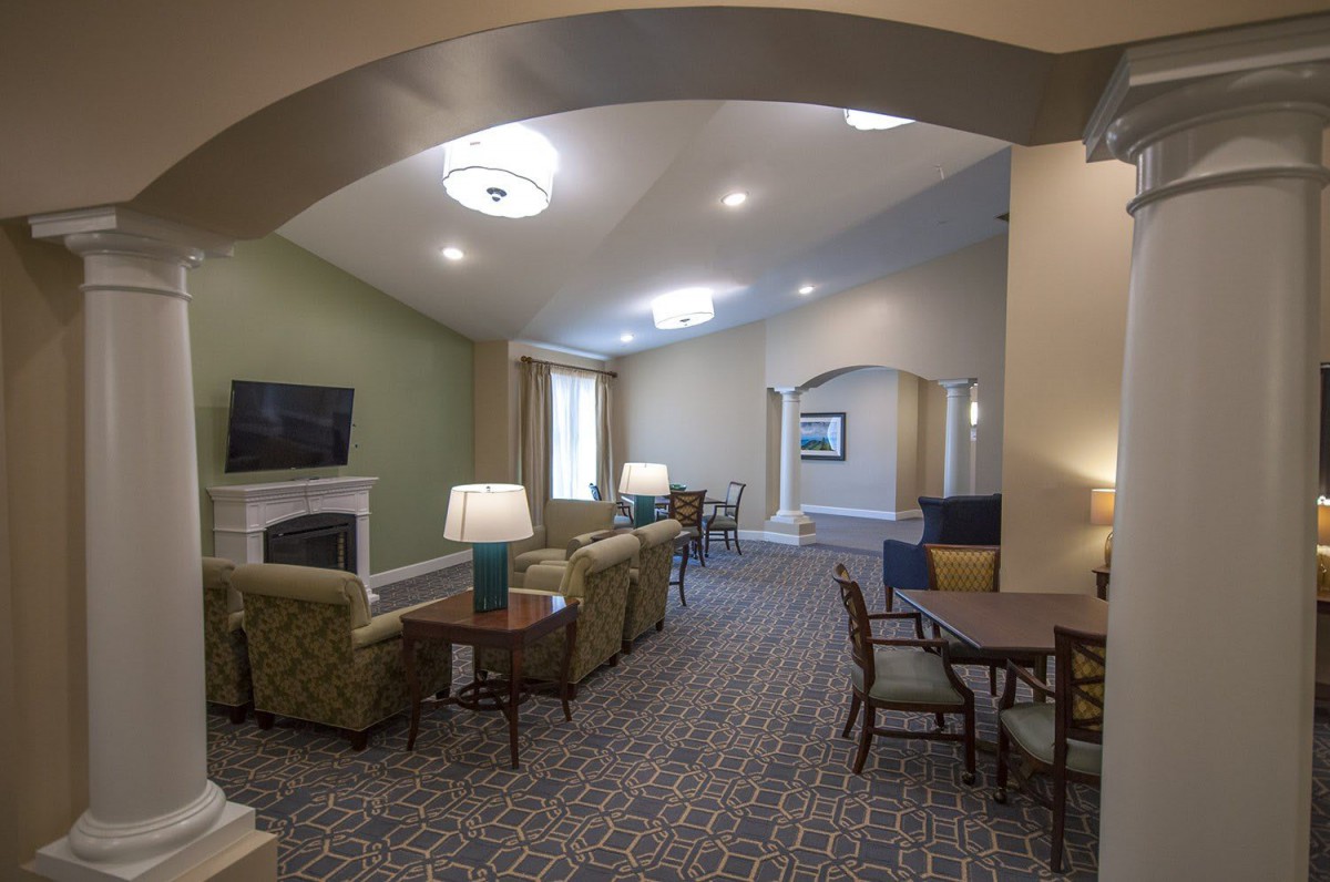 A spacious and well-lit living room with comfortable seating and modern decor.