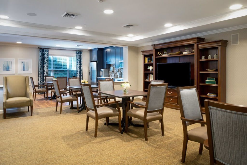 Cozy dining and living area with a modern kitchen and entertainment center.