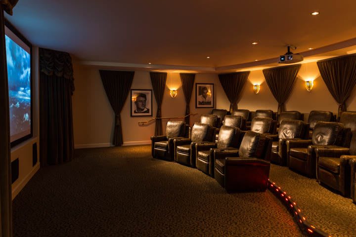 A luxurious home theater with comfortable seating and ambient lighting.