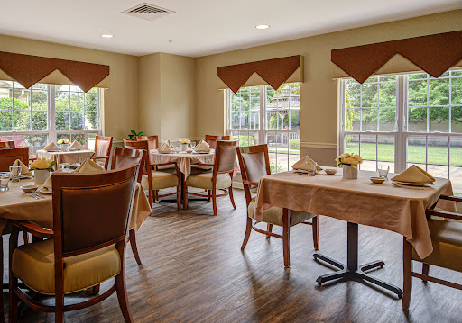 A cozy dining area featuring wooden furniture and ample natural light.