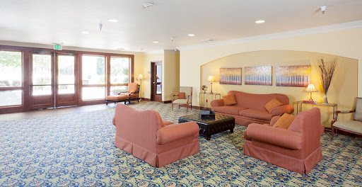 A cozy and inviting lobby space featuring comfortable sofas and a coffee table, ideal for relaxation.